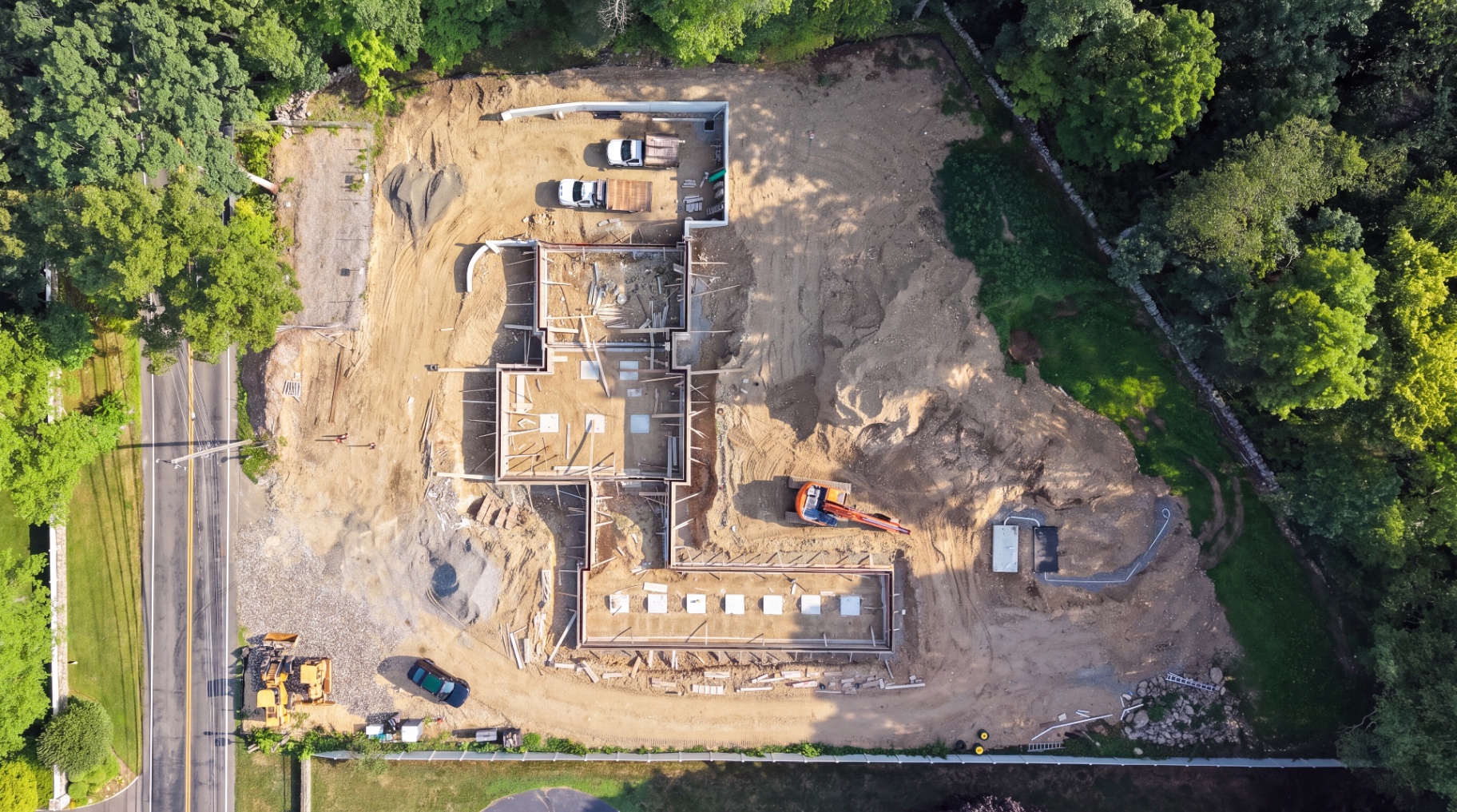Aerial view of foundation walls braced and formed on the building pad.